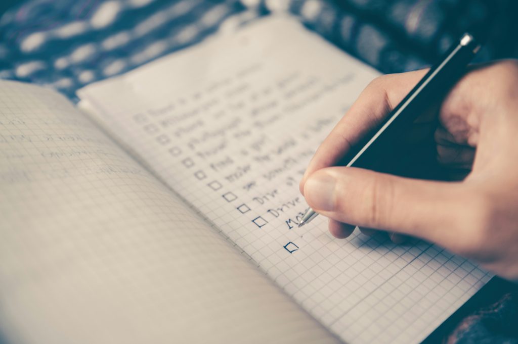 close up of a hand writing a list
