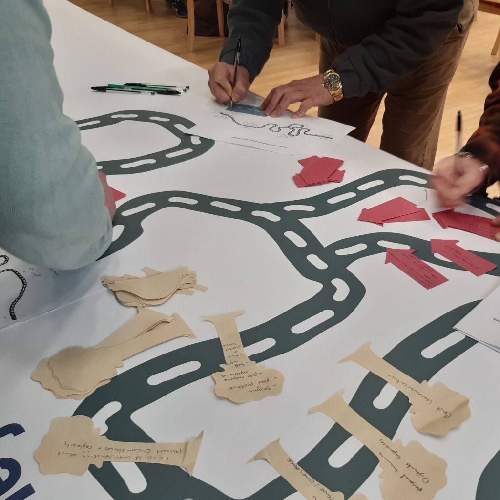 People making a road map from paper